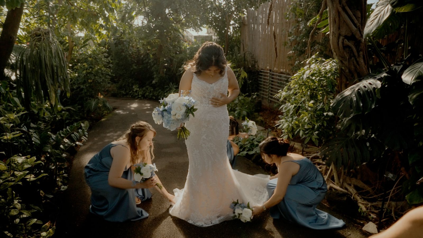 Bridesmaids adjusting the bride's train
